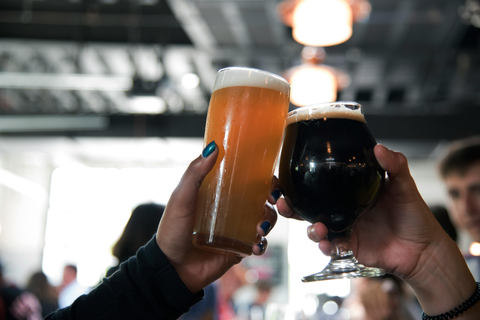 Two people raising a glass of beer