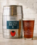 Metal beer keg and glass with Dorking Brewery branding on a light background
