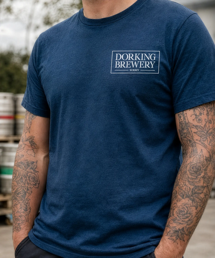Person wearing a blue t-shirt with 'Dorking Brewery' logo.