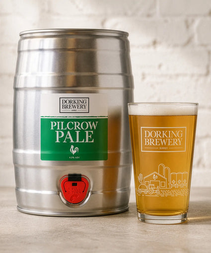 Dorking Brewery Pilcrow Pale beer keg and glass on a wooden surface.
