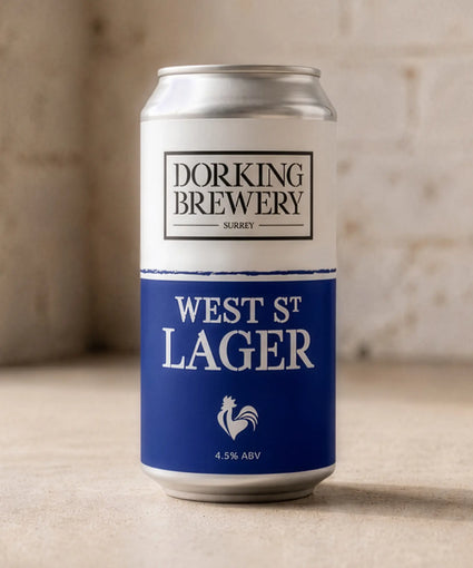 Dorking Brewery West St Lager can on a wooden surface with a blurred background